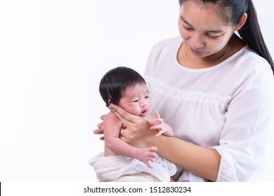 Beautiful young Asian mother hold tiny adorable newborn baby girl 0-1 month with her hand to help baby belch or Making burp after feeding with caring and love, lifestyle health care newborn at home