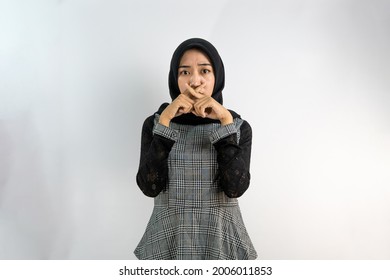 Beautiful Young Asian Muslim Woman With Silent Hand Gesture, Forbidden To Talk, Not Allowed To Make A Sound, Looking At Camera Isolated On White Background