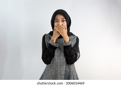 Beautiful Young Asian Muslim Woman Surprised, Not Expecting, With Hands Covering Mouth And Looking At Camera Isolated On White Background