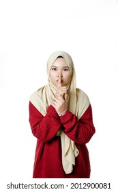 Beautiful Young Asian Muslim Woman With Silent Hand Gesture, Forbidden To Talk, Not Allowed To Make A Sound, Looking At Camera Isolated On White Background