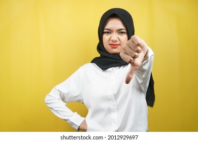 Beautiful Young Asian Muslim Woman Pouting, Belittling, Disappointed, Dissatisfied, Not Good, Bad Job, Lousy, Weak, Looking At Camera Isolated On Yellow Background