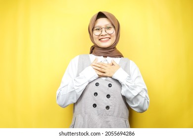 Beautiful Young Asian Muslim Woman Smiling Surprised And Cheerful, With  Hands Holding Chest, Excited, Not Expecting, Looking At Camera Isolated On Yellow Background