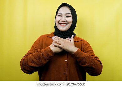 Beautiful Young Asian Muslim Woman Smiling Surprised And Cheerful, With Hands Holding Chest, Excited, Not Expecting, Looking At Camera Isolated