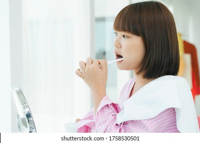 Beautiful Young Asian Thai Black Short Hair Woman Brushing Teeth With Tooth Brush In Restroom.