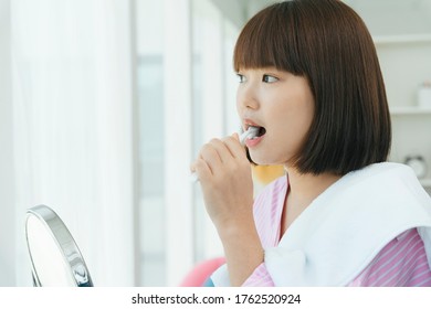 Beautiful Young Asian Thai Black Short Hair Woman Brushing Teeth With Tooth Brush In Restroom.