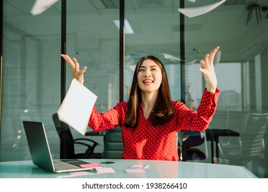 Beautiful Young Asian Thai Businesswoman In Red Shirt Throwing Paper Up In The Air In Office Room.