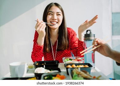 Beautiful Young Asian Thai Woman In Red Shirt Eating Food And Talking With Friend. Bad Habit.