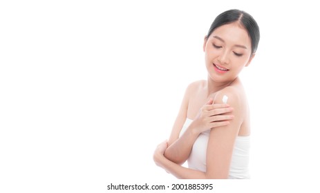 Beautiful young Asian woman applying body lotion natural cream on shoulder after shower with clean skin , Fresh skin , on white background - Facial treatment , Cosmetology , beauty and spa concept 