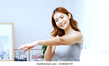 Beautiful young Asian woman applying moisturizing body cream or lotion for soft skin. Skincare concept. - Shutterstock ID 2158436719