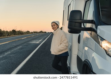 Beautiful young asian woman with beanie leaning on motorhome by the roadside at New Zealand - Powered by Shutterstock