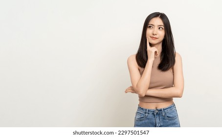 Beautiful young asian woman in brown shirt. Charming female lady standing pose thinking on isolated white blank background. Asian cute people looking copy space for text advertise - Shutterstock ID 2297501547