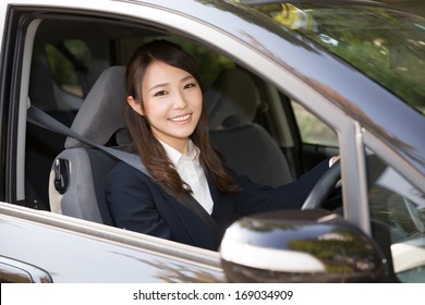 Beautiful Young Asian Woman In A Car