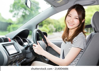 Beautiful Young Asian Woman In A Car