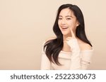 Beautiful young asian woman with clean fresh skin on beige background, Face care, Facial treatment, Cosmetology, beauty and spa, Asian women portrait.