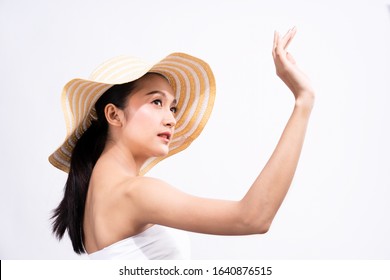 Beautiful Young Asian Woman With Clean Fresh White Skin Raising Her Arm And Hand In Protection Sunshine In Isolated White Background. Facial Treatment, Cosmetology, Sun Screen Cream Advertise Concept.