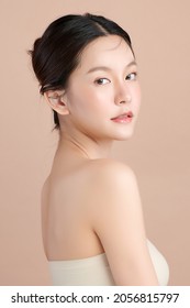 Beautiful young asian woman with clean fresh skin on beige background, Face care, Facial treatment, Cosmetology, beauty and spa, Asian women portrait. - Shutterstock ID 2056815797