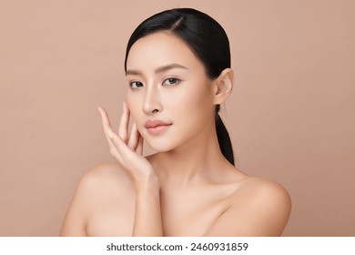 Beautiful young asian woman with clean fresh skin on beige background, Face care, Facial treatment, Cosmetology, beauty and spa, Asian women portrait. - Powered by Shutterstock