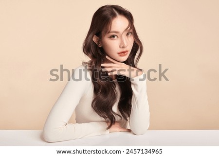 Similar – Image, Stock Photo Portrait of young beautiful brunette smiling woman sitting in the sand in front of a forest