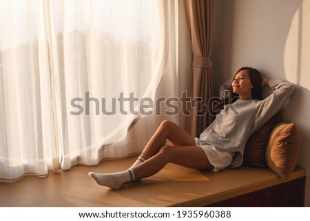 Similar – Image, Stock Photo Young adult woman lying in bed and with her cat and pile of books in her hands