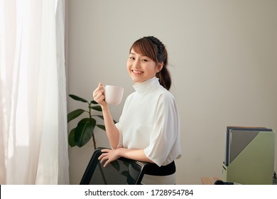 beautiful young Asian woman drinking coffee
