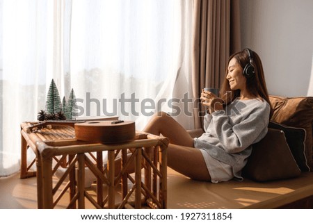 Similar – Image, Stock Photo A woman enjoying listening to music with her headphones