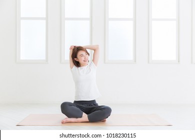 Beautiful young asian woman exercising in the room - Powered by Shutterstock