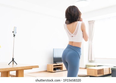 Beautiful Young Asian Woman Exercising In The Room,taken Pictures Of Her Self,back View