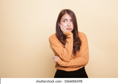 Beautiful Young Asian Woman Get Bored On Beige Background