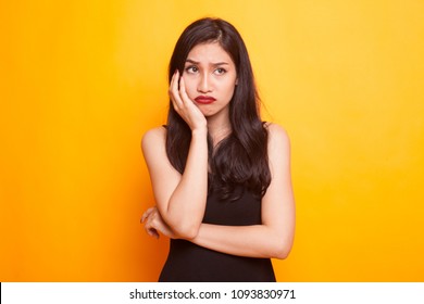 Beautiful Young Asian Woman Get Bored On Yellow Background