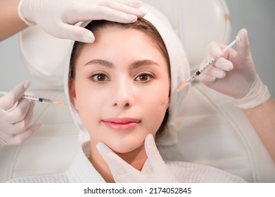 Beautiful Young Asian Woman Getting Cosmetology Treatment Facial Skin Injection By Doctor Beautician In Beauty Clinic. Female Making Mesotherapy Beauty Care With Anti-aging Of Face In Surgery Clinic.