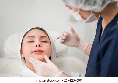 Beautiful Young Asian Woman Getting Cosmetology Treatment Facial Skin Injection By Doctor Beautician In Beauty Clinic. Female Making Mesotherapy Beauty Care With Anti-aging Of Face In Surgery Clinic.