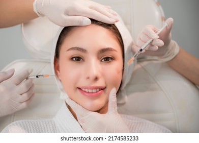 Beautiful Young Asian Woman Getting Cosmetology Treatment Facial Skin Injection By Doctor Beautician In Beauty Clinic. Female Making Mesotherapy Beauty Care With Anti-aging Of Face In Surgery Clinic.