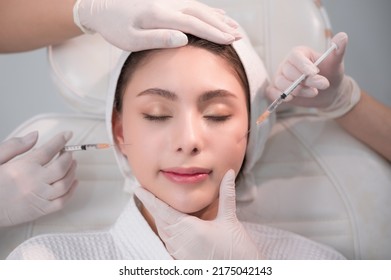 Beautiful Young Asian Woman Getting Cosmetology Treatment Facial Skin Injection By Doctor Beautician In Beauty Clinic. Female Making Mesotherapy Beauty Care With Anti-aging Of Face In Surgery Clinic.