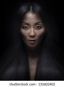 Beautiful Young Asian Woman With Long Hair On Dark Background