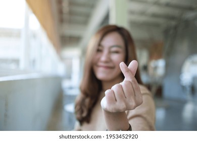 A Beautiful Young Asian Woman Making And Showing Mini Heart Hand Sign