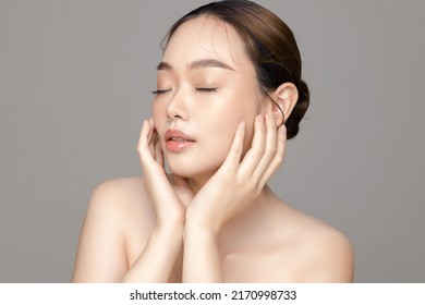 Beautiful Young Asian Woman Model With Perfect Clean Fresh Skin On Grey Background. Face Care, Facial Treatment, Cosmetology, Plastic Surgery, Lovely Girl Portrait In Studio.