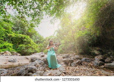 Beautiful Young Asian Woman Playing Violin Outside Nature.