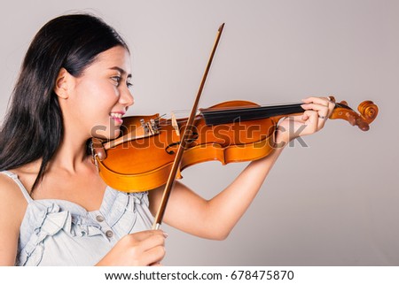 beautiful young asian woman playing violin
