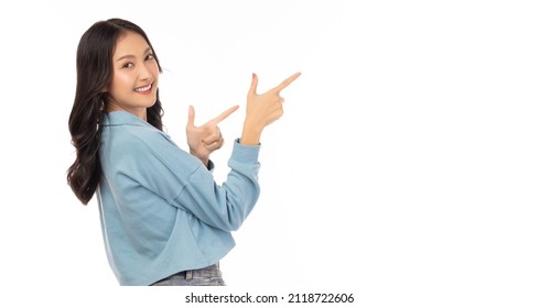 Beautiful young Asian woman pointing up to copy space and looking at camera with smile face and happiness Pretty girl act like a satisfied product, use for advertising isolated on white background - Powered by Shutterstock