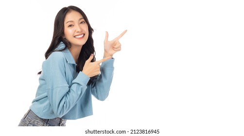 Beautiful young Asian woman pointing up to copy space and looking at camera with smile face and happy Pretty girl act like a satisfied product, use for advertising with isolated on white background - Shutterstock ID 2123816945