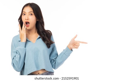 Beautiful young Asian woman pointing up to copy space and looking at camera with surprise face and excited Excited girl says wow and mouth open Use for advertising with isolated on white background