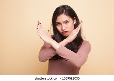 Beautiful young Asian woman say no on beige background - Shutterstock ID 1059092030