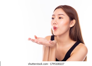 Beautiful Young Asian Woman Sending And Blowing Air Kiss Over Isolated On White Background. Demonstrates Her Good Feeling, Says Goodbye On Distance. Young Pretty Female Make Air Kiss. Copy Space