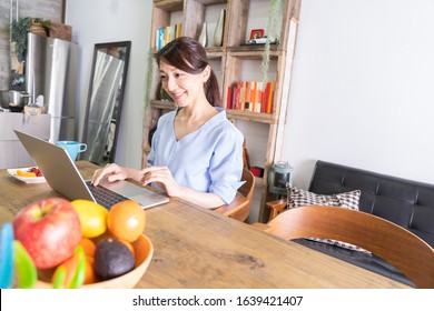 Beautiful Young Asian Woman Using Laptop