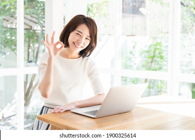 Beautiful Young Asian Woman Using Laptop