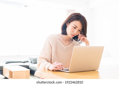 Beautiful young asian woman using laptop,think,