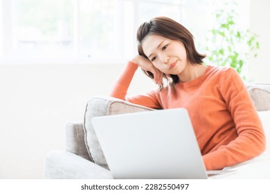 Beautiful young asian woman using laptop, think - Shutterstock ID 2282550497