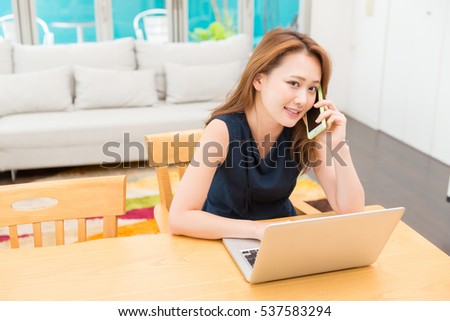 Beautiful young asian woman using laptop,telephone