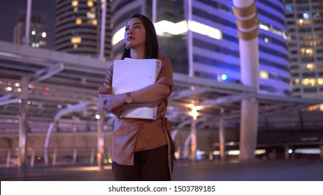 Beautiful Young Asian Woman Walking In The Night City Streets