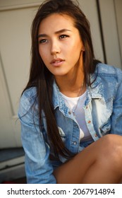 Beautiful Young Asian Woman Walking On A City Street With A White Dog. Summer Time. Outdoors.